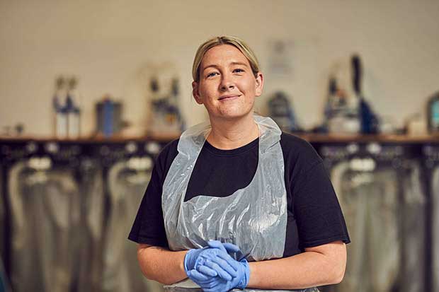 University of Winchester - woman in a bib ans overalls.